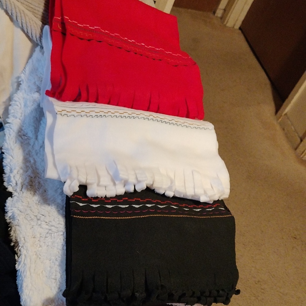 Handmade plush scarves three different colors red, white and black.